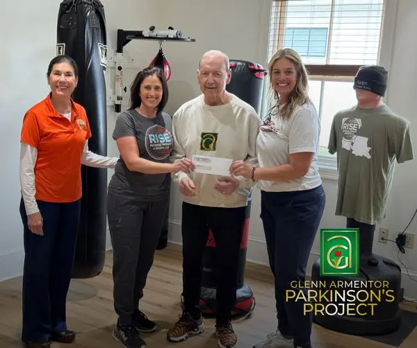 Parkinson's Project 8 Glenn Armentor and the Parkinson’s Project team presenting a donation