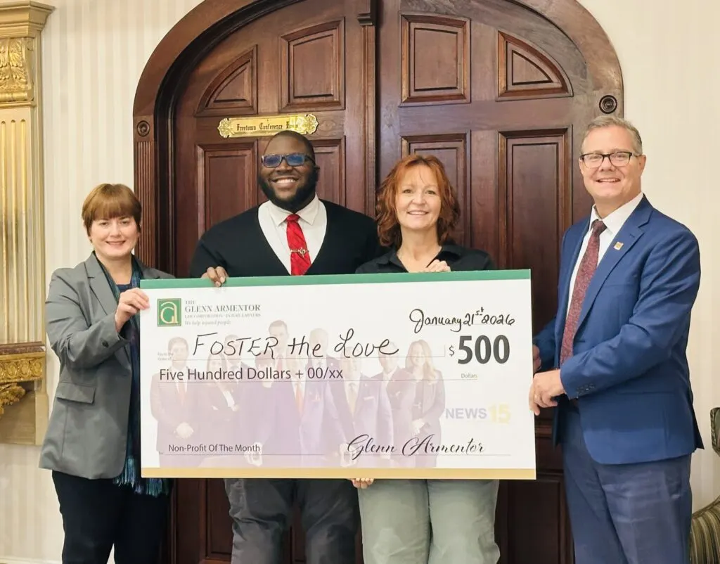Glenn Armentor presenting a donation to Foster the Love Louisiana