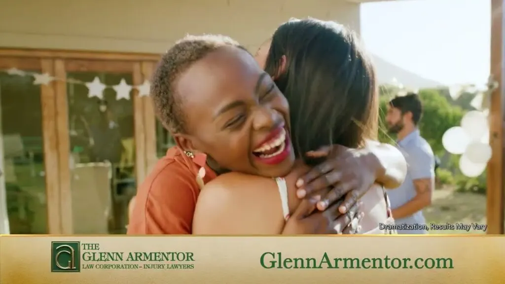 Two friends hugging at a neighborhood gathering – Acadiana, We’re With You video still