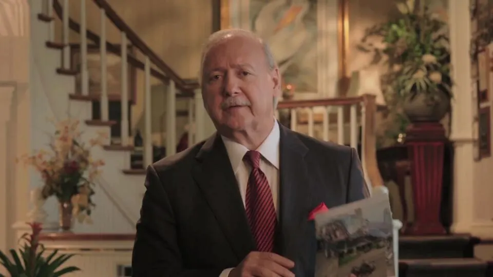 Glenn Armentor holding an accident scene photo – Accident Investigation Team video still